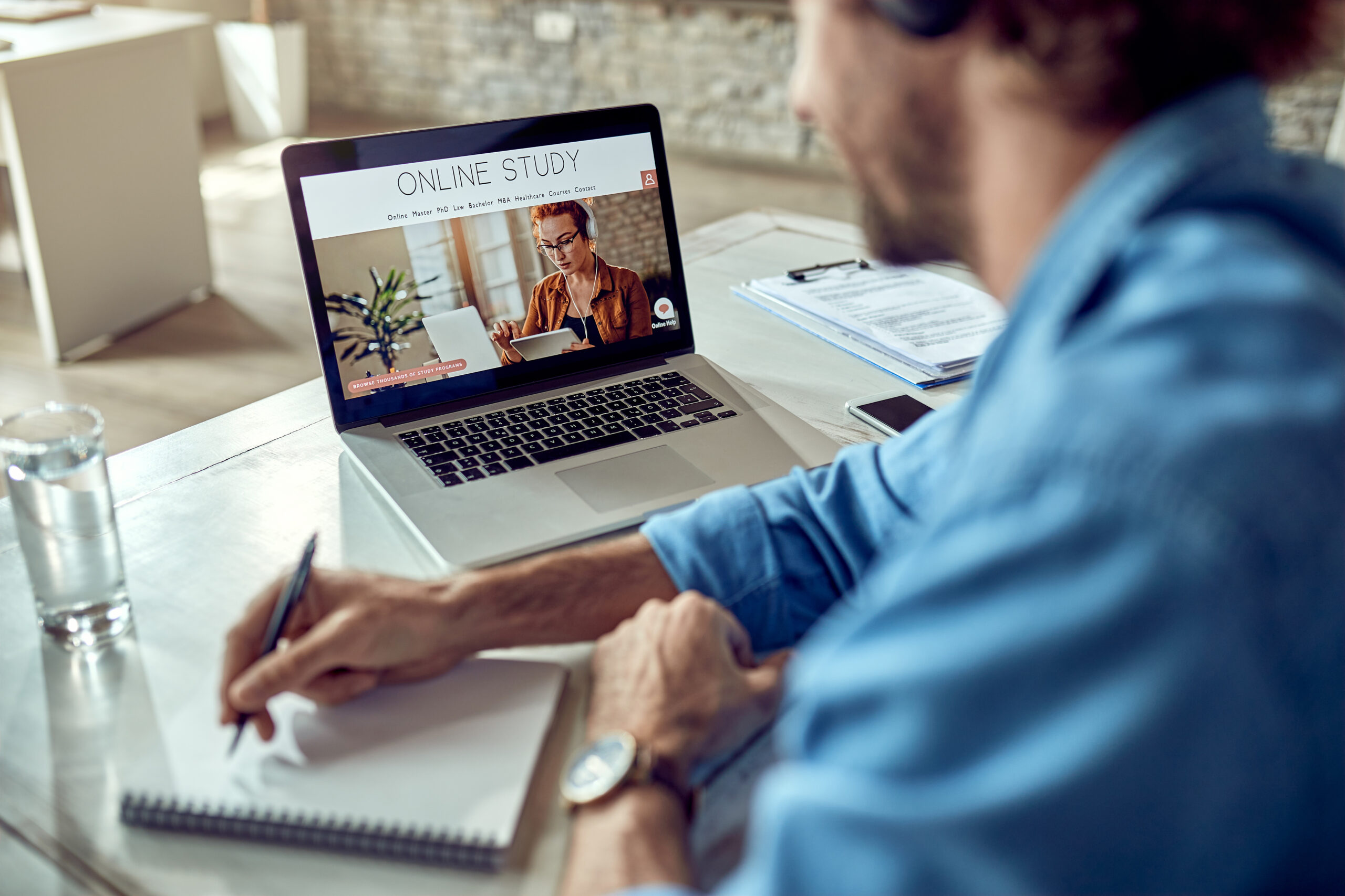 Close-up of freelancer learning online while using laptop in the office.